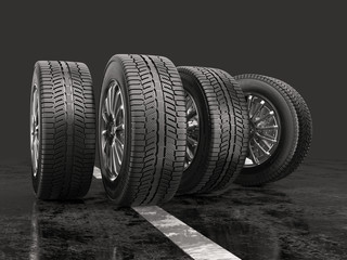 Fototapeta Four car tires rolling on a road on a gray background. obraz