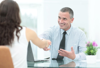 Obraz premium Two happy young business people in formalwear smiling