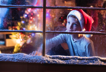 On Christmas night a lovely little girl looking out the window