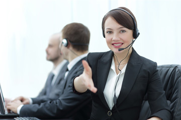 Happy businesswoman in headset invites to cooperation