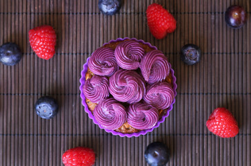 Mufin with purple cream and fruits