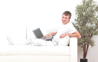 Goodlooking young man relaxing at home sitting in living room