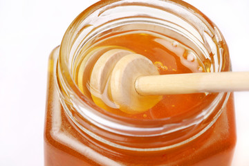 honey in a jar on a white background