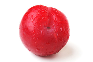plum with droplets of water on a white background