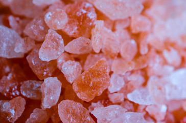 Pink salt close up. Himalayan rose salt crystals backdrop, macro view.
