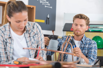 plumbers soldering copper central heating pipes