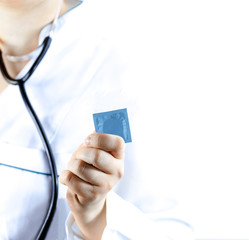 Unrecognizable doctor gives condom, concept of safe sex. Woman doctor show blue condom, Isolated on white background