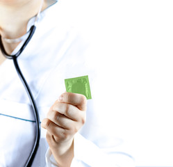 Female doctor holding condom for aids prevention and birth control. Doctor show green condom, Isolated on white background
