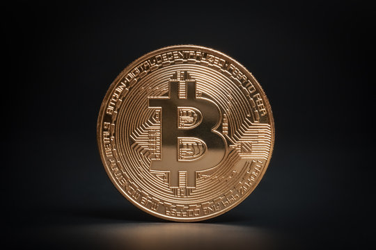 macro bronze bitcoin on black background. virtual cryptocurrency concept.