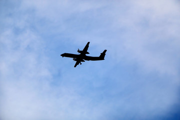 Plane silhouette on a cloudy sky. 
