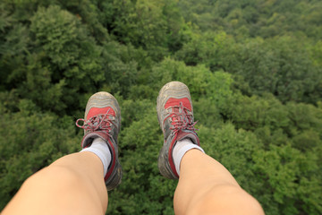 hiker legs on the top of forest