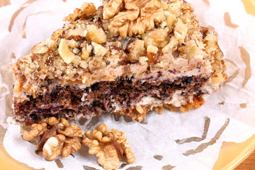 portion of white and brown chocolate walnut cake with walnuts
