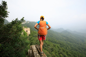 young woman hiker hiking on great wall