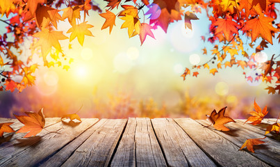 Wooden Table With Orange Leaves And Blurred Autumn Background
