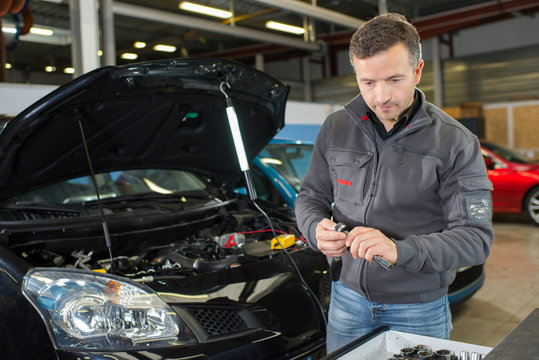 car mechanic working with tool in service workshop