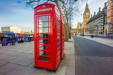 Fototapeta na wymiar London, England - Traditional British red telephone box at Victoria Embankment with Big Ben at background
