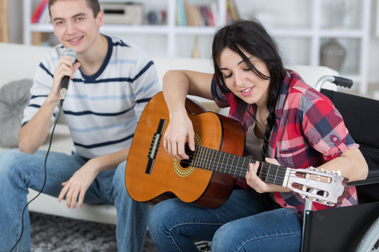 friends singing by guitar indoor