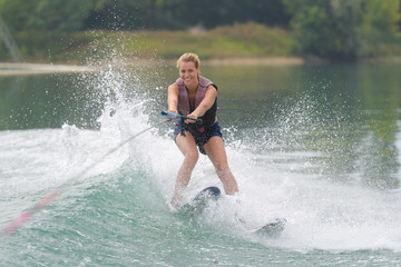 young girl water skiing on a slalom course