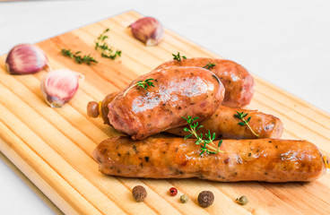 Grilled barbecue chorizo meat sausages on a wooden board