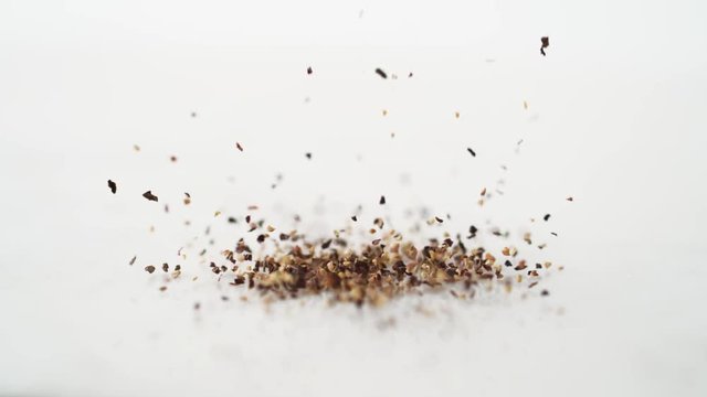 Ground black pepper sprinkled. Shot with high speed camera, phantom flex 4K. Slow Motion.