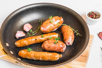 Grilled barbecue chorizo meat sausages in a frying pan