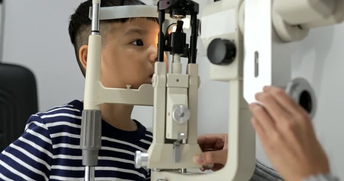 Little kids doing eye test in optical shop