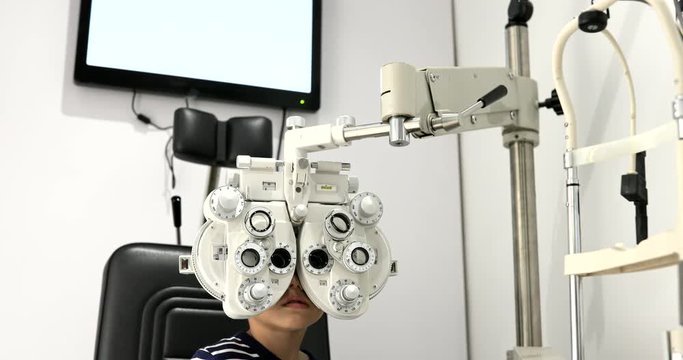 Asian little boy undergo eye exam