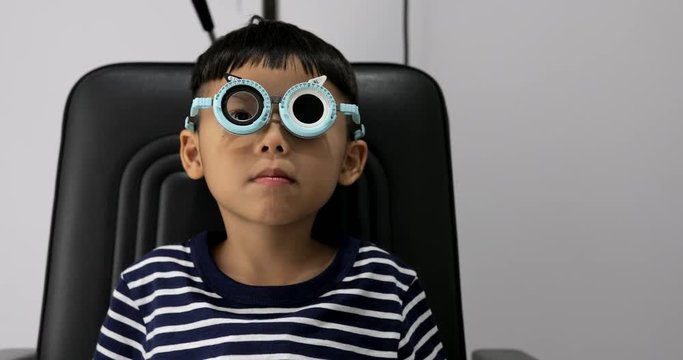 Asian boy doing eye test