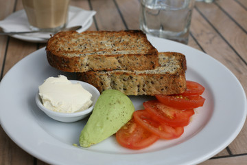 Avocado, tomato, wholegrain bread for breakfast
