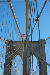 Brooklyn Suspension Bridge cables seen when walking in Manhattan on a sunny spring day in New York, USA