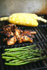 Food on the barbecue - chicken, sweet corn and asparagus