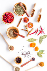 Spicy food cooking with spices and dry herbs white kitchen desk background top view pattern