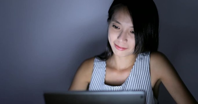Woman working on laptop computer at night