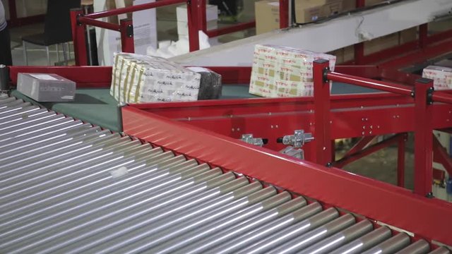 Packages at Conveyor Belt in Sorting Warehouse