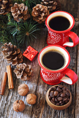 Winter coffee for two, coffee beans, pine cones and New Year tree decorations