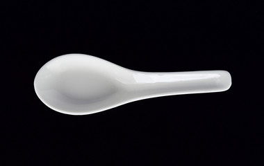 White spoon on black