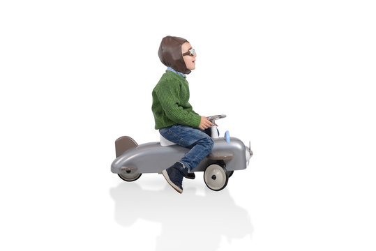 Kid plays with a small arplane. Isolated on white background