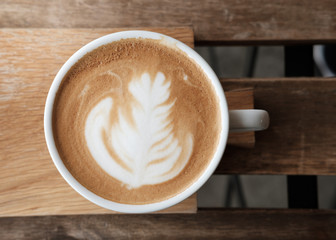 A cup of coffee put on wooden board