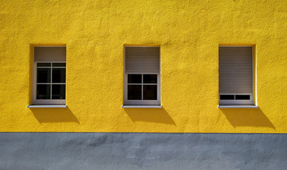 Yellow painted house with Windows and Shutters