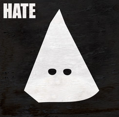 kkk hood representing hate and racism on wood grain texture