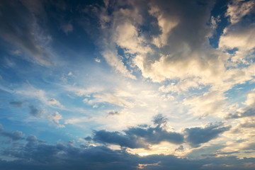 Sky background at sunset,Sky blue and orange light of the sun through the clouds in the sky