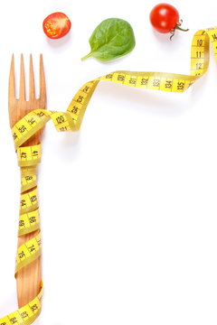 Frame of fork wrapped centimeter and fresh vegetables, concept of lose weight and healthy nutrition