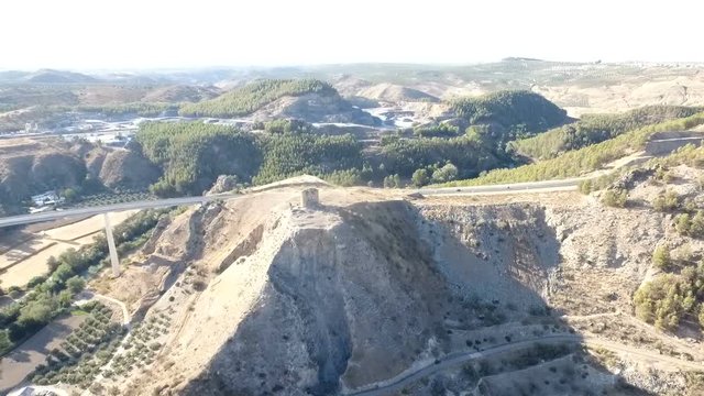 1080p Aerial, Flight over a highway bridge and down river village and olive orchards, Andalucia, Spain. Staright rows of olive trees and high rise bridge with going on cars. Way to Cordoba