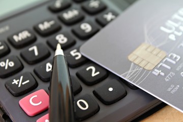 Business, finance, saving money, banking, loan, investment or credit card concept : Credit card and pen on calculator