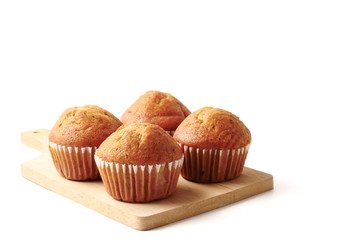 Banana cupcakes on a wooden tray, white background, Free space for text.