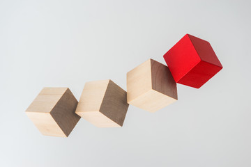 Business concept - Abstract geometric real floating wooden cube on grey background and it's not 3D render. the symbol of leadership, teamwork and growth.