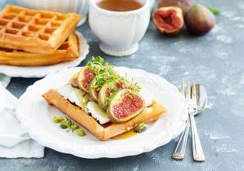 Wafers with figs, brie cheese and honey. Delicious wholesome breakfast.