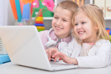 brother and sister using laptop