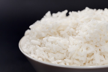 cooked rice on bowl on black background