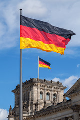 Two German flags against a blue sky